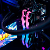 Close-up of computer hardware with pink and black components on a dark background