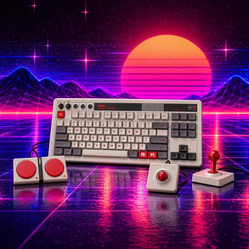 A retro keyboard with grey and off-white keys and red accent keys, shown with a red-topped joystick and large red buttons