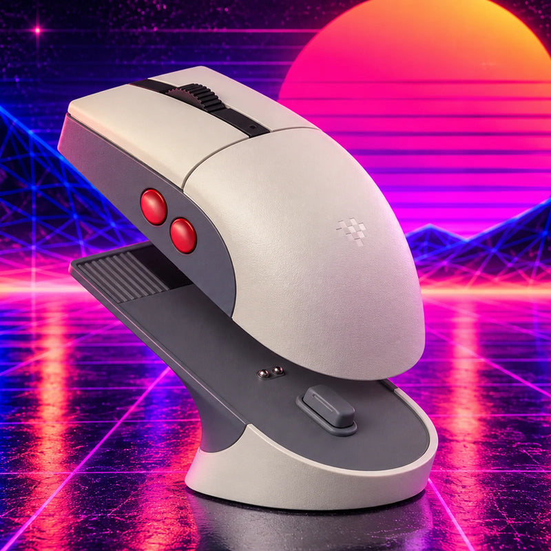 An off-white retro wireless mouse with two red side buttons, sitting on its dock